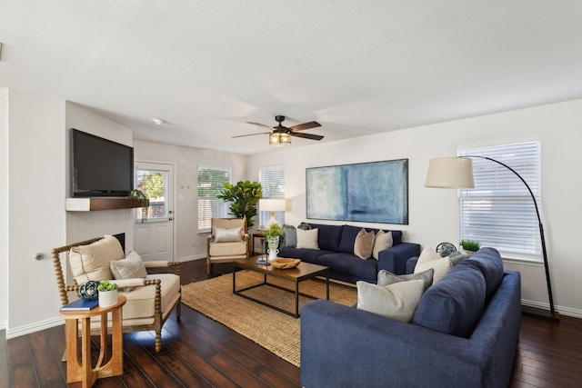 living room featuring dark hardwood / wood-style flooring and ceiling fan