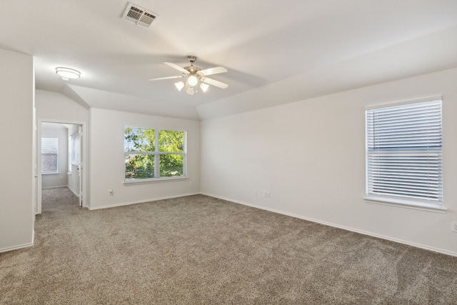 carpeted empty room featuring ceiling fan and lofted ceiling