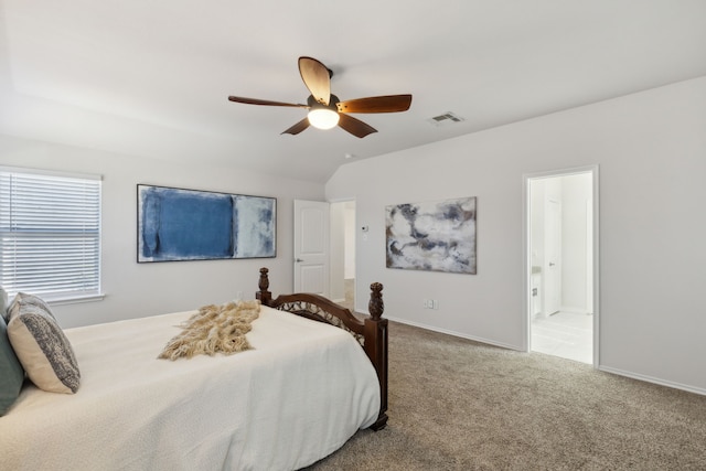 carpeted bedroom with ceiling fan, ensuite bathroom, and lofted ceiling