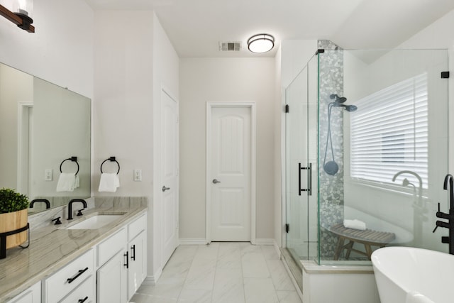 bathroom featuring vanity and separate shower and tub