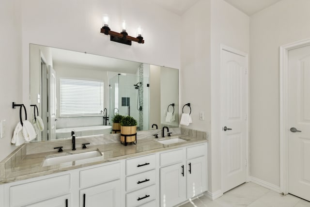 bathroom featuring vanity and independent shower and bath