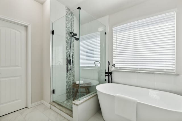 bathroom featuring shower with separate bathtub