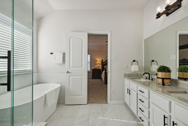 bathroom with a bathtub, vanity, and lofted ceiling