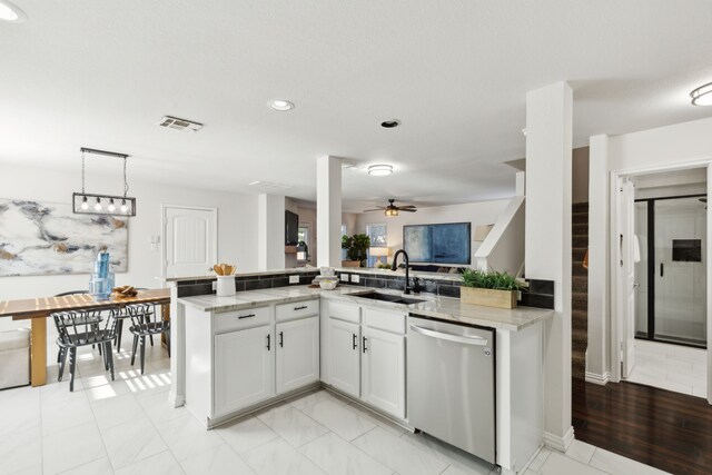 kitchen with dishwasher, kitchen peninsula, white cabinetry, and sink