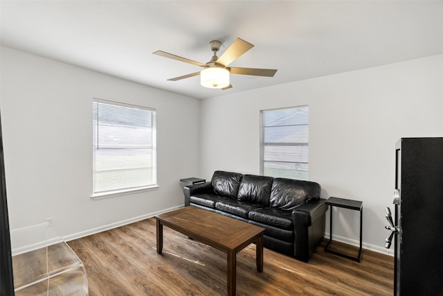 living room with ceiling fan, a healthy amount of sunlight, and dark hardwood / wood-style floors