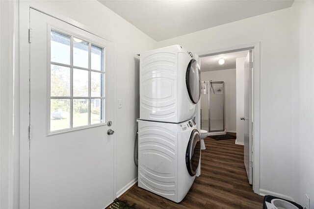 washroom with dark hardwood / wood-style flooring and stacked washer / dryer