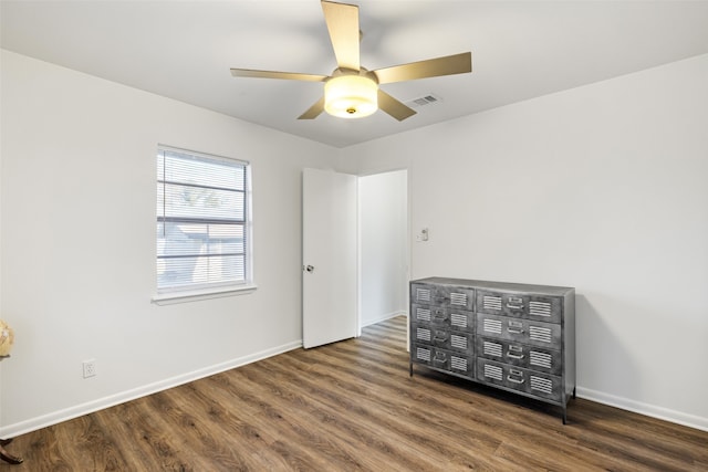 unfurnished bedroom featuring dark hardwood / wood-style floors and ceiling fan