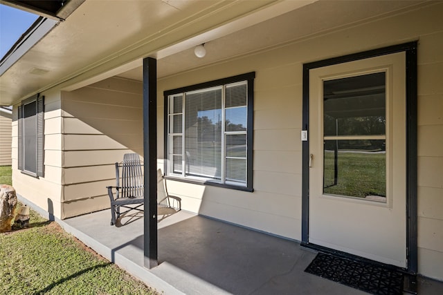 view of exterior entry featuring a porch