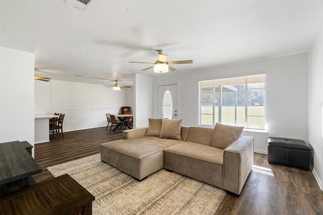 living room with wood-type flooring and ceiling fan