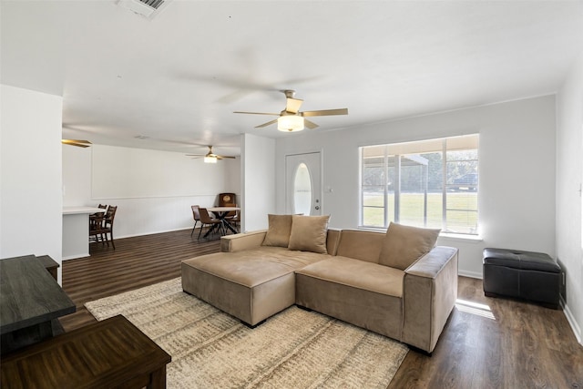 living room with wood-type flooring and ceiling fan