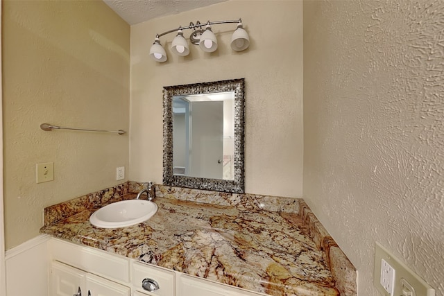 bathroom featuring vanity and a textured ceiling