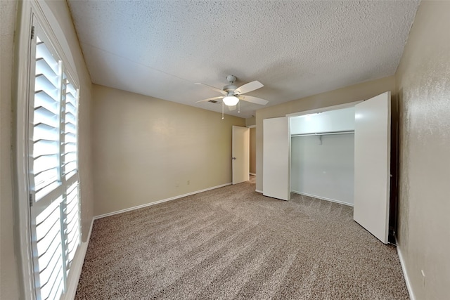 unfurnished bedroom with carpet, a textured ceiling, a closet, and ceiling fan