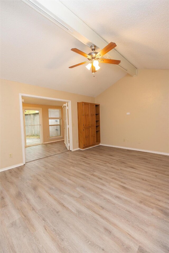 carpeted empty room featuring ceiling fan, a healthy amount of sunlight, and a textured ceiling