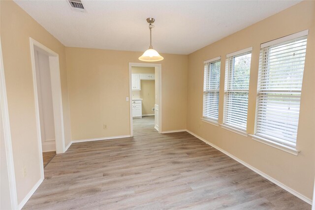 unfurnished bedroom featuring a textured ceiling, ceiling fan, light carpet, and a closet