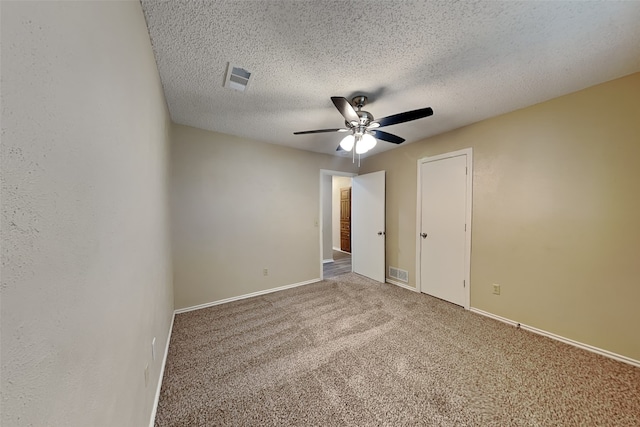 unfurnished bedroom featuring carpet flooring, ceiling fan, and a textured ceiling