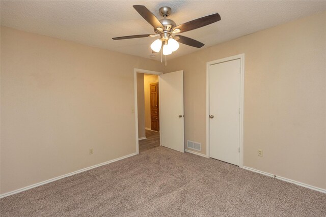 spare room with ceiling fan, light hardwood / wood-style flooring, lofted ceiling with beams, and a textured ceiling