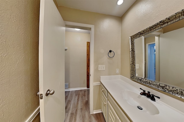 bathroom with hardwood / wood-style floors and vanity