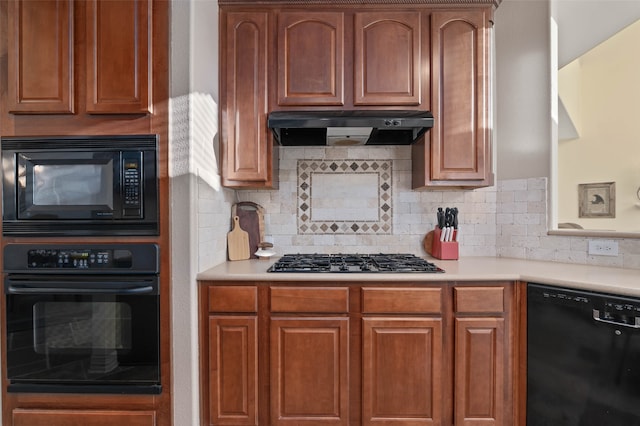 kitchen featuring decorative backsplash and black appliances