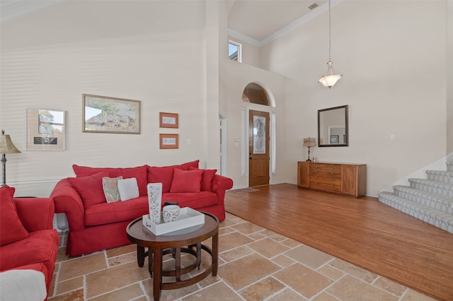 living room featuring high vaulted ceiling, ornamental molding, and hardwood / wood-style flooring