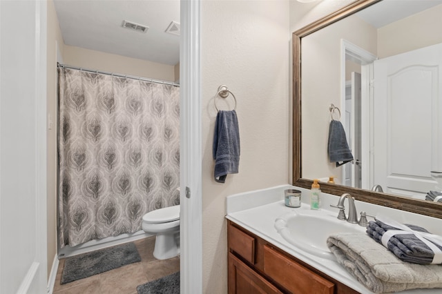 bathroom featuring tile patterned flooring, vanity, toilet, and a shower with curtain