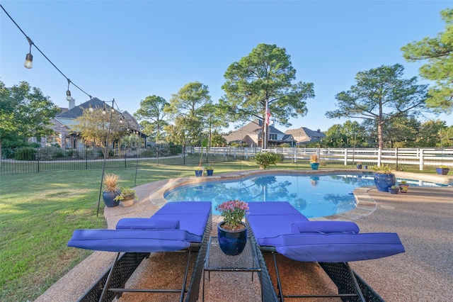 view of pool featuring a yard