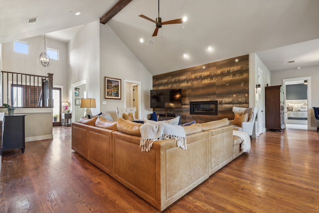 living room with beam ceiling, dark hardwood / wood-style flooring, high vaulted ceiling, and ceiling fan with notable chandelier