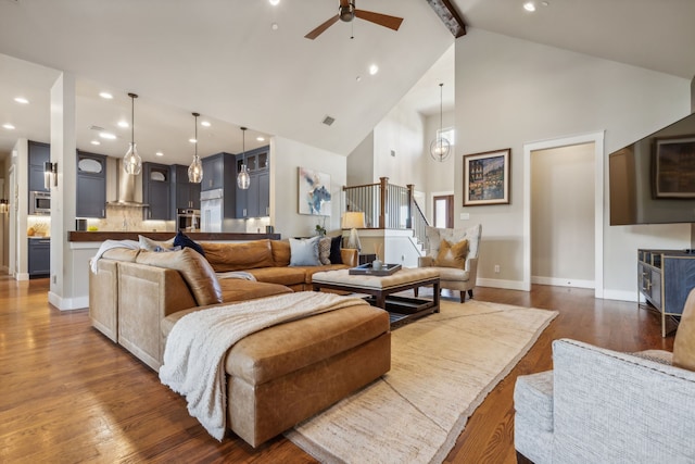 living room featuring beamed ceiling, dark hardwood / wood-style flooring, high vaulted ceiling, and ceiling fan