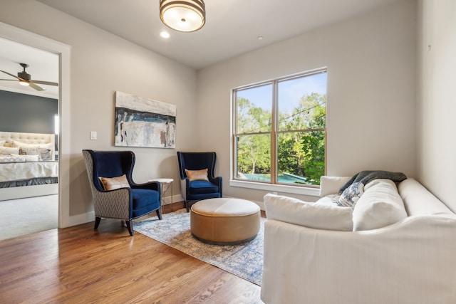 living room featuring ceiling fan and hardwood / wood-style floors