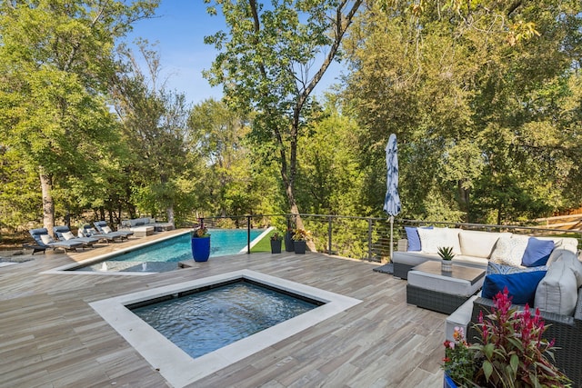 view of pool with an outdoor living space and a wooden deck