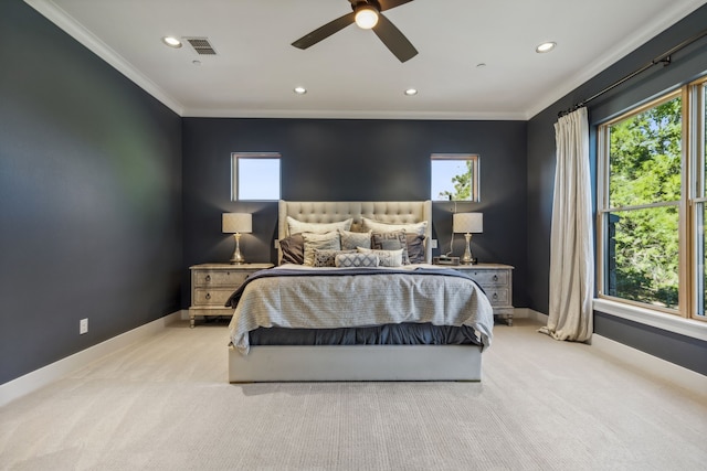 carpeted bedroom featuring ceiling fan and crown molding