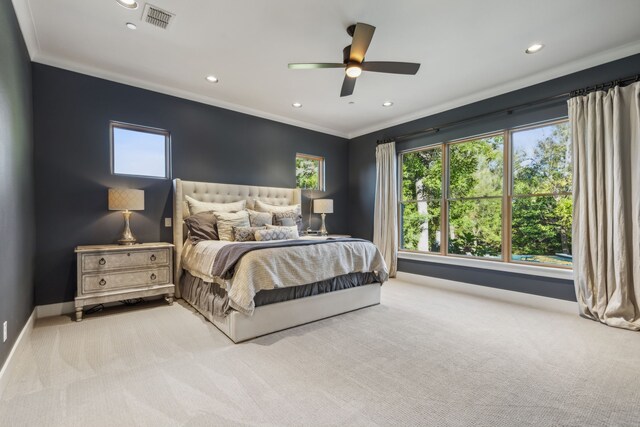 bedroom featuring ceiling fan, ornamental molding, and light carpet