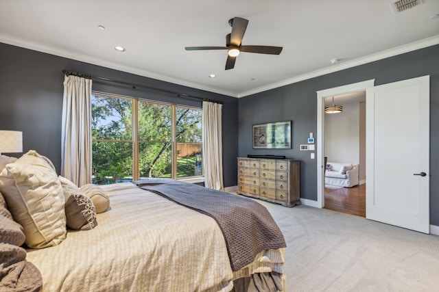 carpeted bedroom featuring ceiling fan and ornamental molding