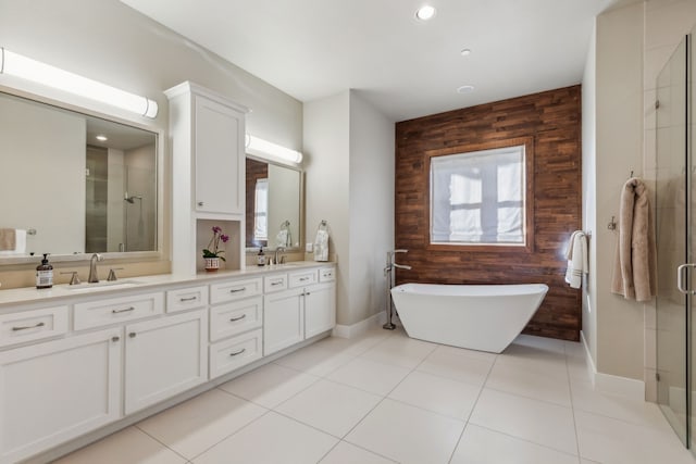 bathroom featuring tile patterned floors, wood walls, vanity, and independent shower and bath