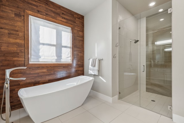 bathroom featuring shower with separate bathtub, tile patterned floors, and wooden walls