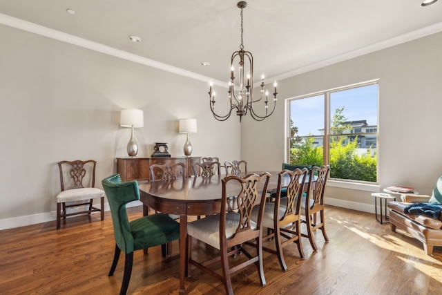 dining area featuring wood-type flooring, crown molding, and a chandelier