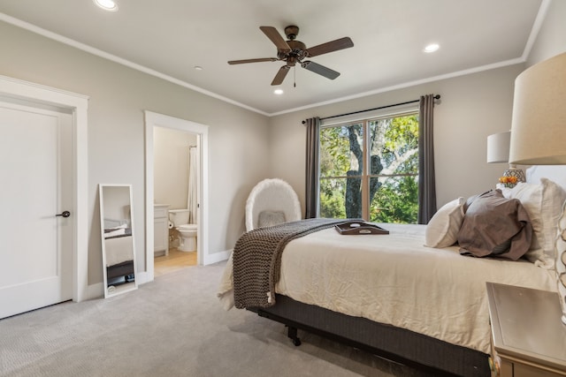 bedroom featuring light carpet, ensuite bath, ceiling fan, and crown molding