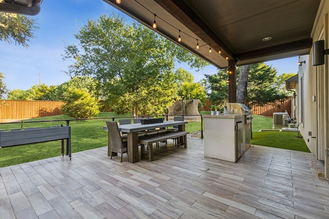 view of patio / terrace with area for grilling, exterior kitchen, and central AC