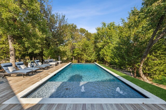 view of swimming pool with a wooden deck