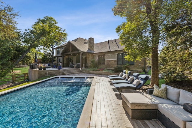 view of pool with outdoor lounge area, a patio, and pool water feature