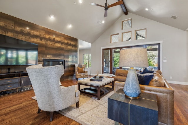 living room with ceiling fan, hardwood / wood-style floors, high vaulted ceiling, and beamed ceiling