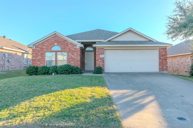 ranch-style house featuring a garage and a front lawn