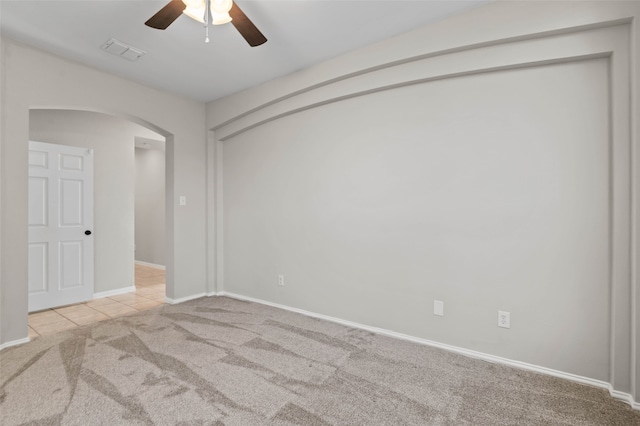 carpeted empty room featuring ceiling fan