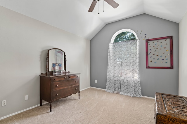 living area featuring lofted ceiling, light colored carpet, and ceiling fan