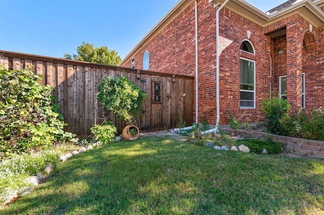 view of home's exterior with a yard