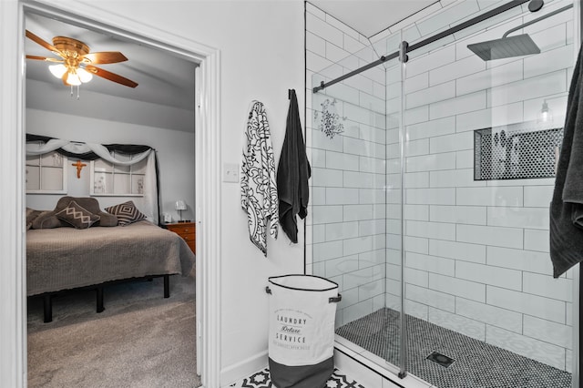 bathroom featuring ceiling fan and a shower with shower door