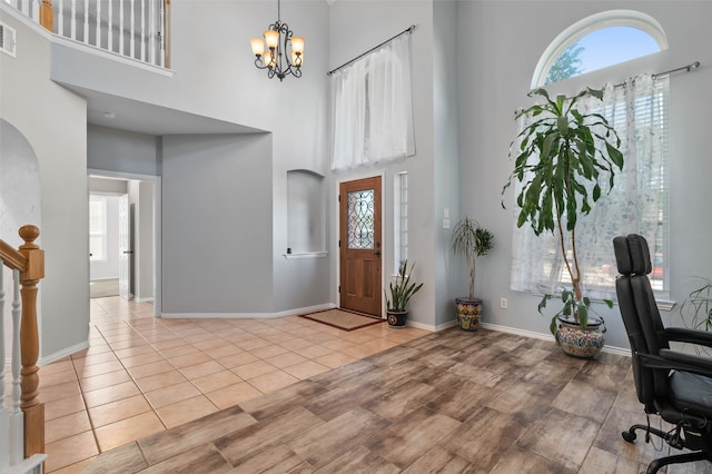 foyer entrance featuring a notable chandelier and a high ceiling