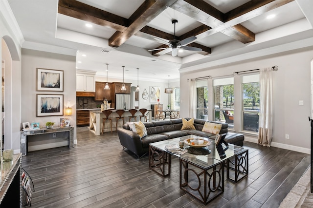 living room with ceiling fan, dark hardwood / wood-style flooring, beamed ceiling, and coffered ceiling