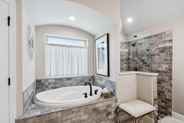 bathroom featuring shower with separate bathtub