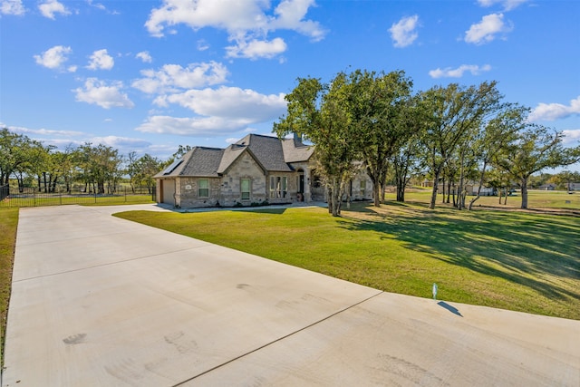 view of front of house featuring a front lawn and a garage