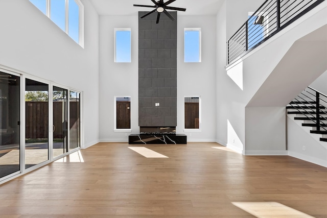 unfurnished living room featuring a wealth of natural light and a high ceiling